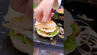 Chinese Burger Beautiful girl frying eggs outdoors